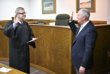 Enoch Autry/The Clayton Tribune. Rabun County Probate Judge Hobie Jones swears-in Rick Story as the newest member of the Rabun County Board of Education Tuesday, May 7.