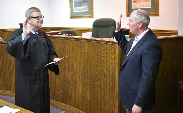 Enoch Autry/The Clayton Tribune. Rabun County Probate Judge Hobie Jones swears-in Rick Story as the newest member of the Rabun County Board of Education Tuesday, May 7.