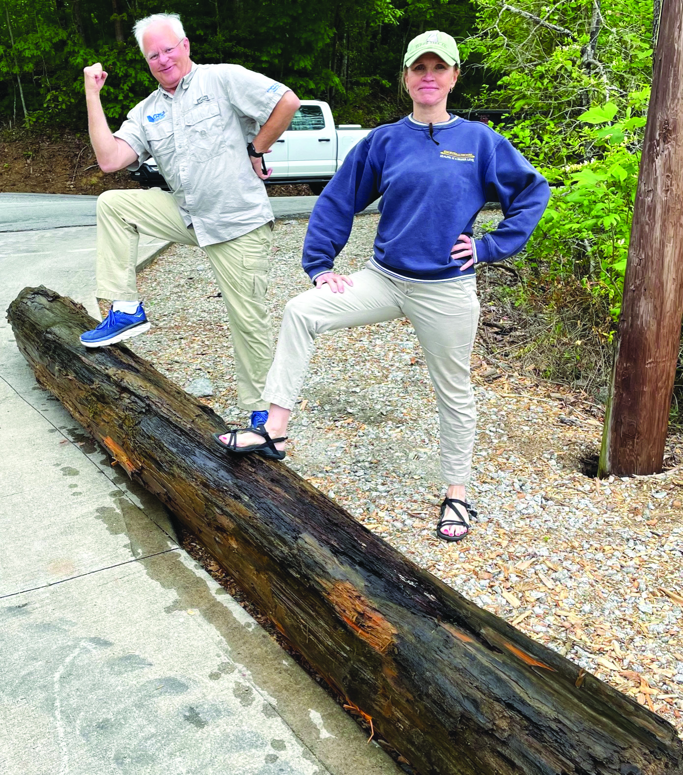 Submitted photo.  Jef Fincher and Vicki Veal, volunteers with the LBCA “Clean Up the Lake Day” event on Friday, May 12, show off a huge log they hauled-in during the event.