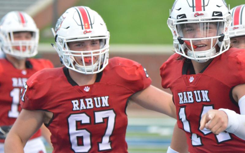 Rabun County offensive lineman Will Hightower (67) and quarterback Gunner Stockton (14) celebrate after a touchdown during the first half against Bremen in the Erk Russell Classic at Georgia Southern’s Paulson Stadium in Statesboro last Saturday night. (Wayne Knuckles/The Clayton Tribune)