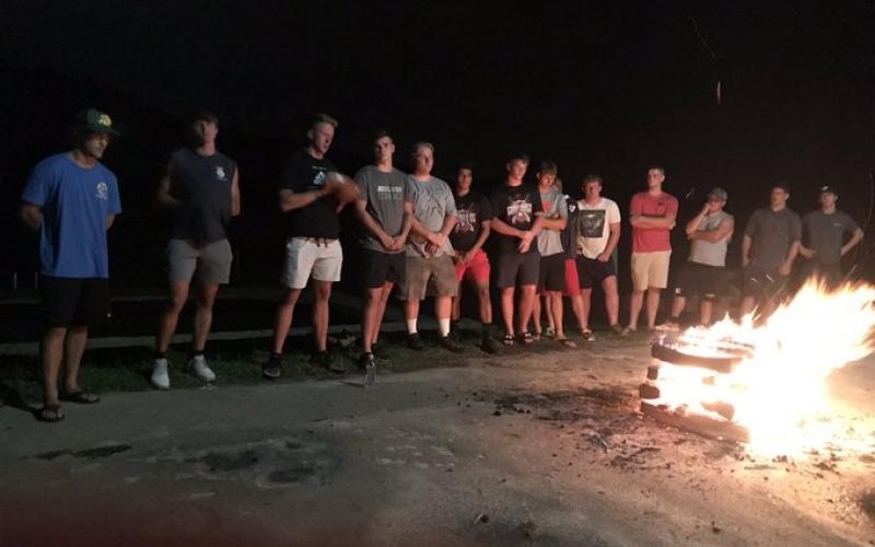 Rabun County football players stand around a fire at Currahee Mountain. (Submitted Photo)