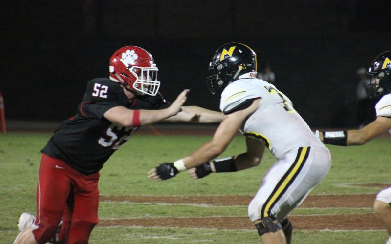 Rabun County defensive lineman Phillip Roberson, left, works around a North Murray offensive lineman during the second half at Frank Snyder Memorial Stadium in Tiger last Friday night. (Glendon Poe/The Clayton Tribune)