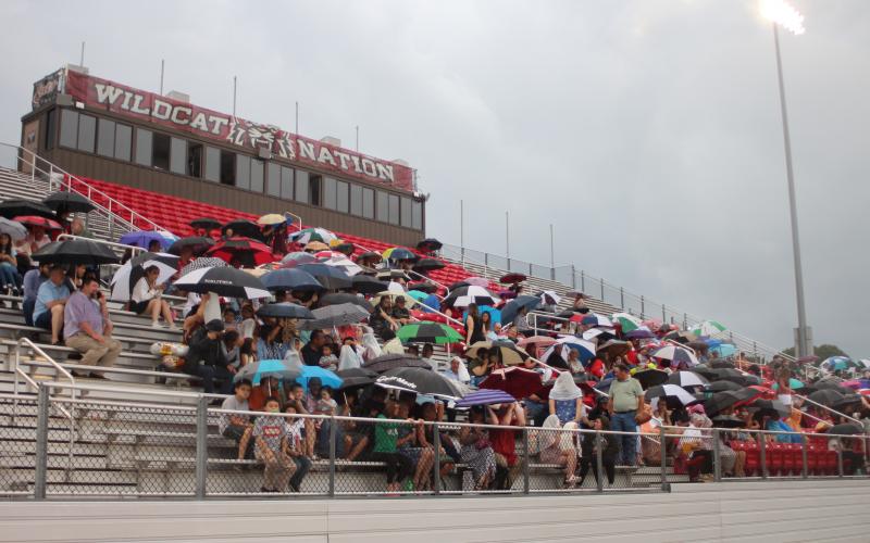Megan Broome/The Clayton Tribune. Friends and family members of graduates brave the wind and rain to watch the Class of 2021 graduate. The ceremony had to be moved inside shortly after due to rain and threats of lightning strikes in the area. 