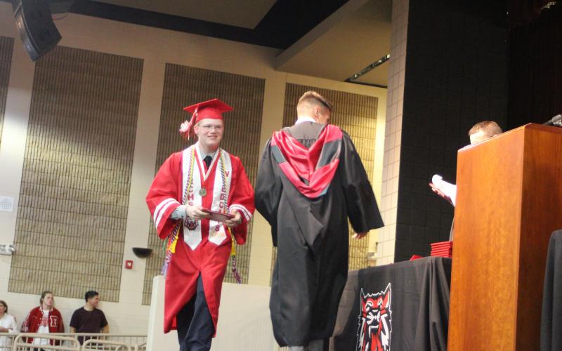Megan Broome/The Clayton Tribune. Graduate and Historian for the Class of 2021 Chandler Hensley is all smiles as he walks across the stage in the Fine Arts Building for last Friday’s graduation ceremony to accept his high school diploma. 