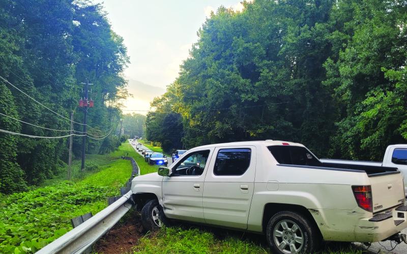 Megan Broome/The Clayton Tribune. Rabun County emergency personnel work the scene of a single vehicle crash on Highway 76 east just before the intersection of Old Chechero Road in Clayton on Aug. 15. A Rosman, N.C., man experienced a medical emergency prior to crashing into a guardrail. 