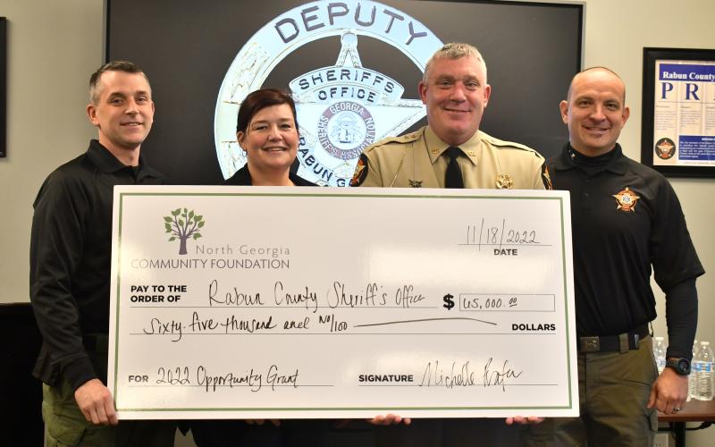 Megan Broome/The Clayton Tribune. RCSO Chief Deputy Scott Cheek; Captain Beth Darnell; Sheriff Chad Nichols; and Chaplain John Hutcheson are presented with the 2022 Opportunity Grant from the North Georgia Community Foundation.