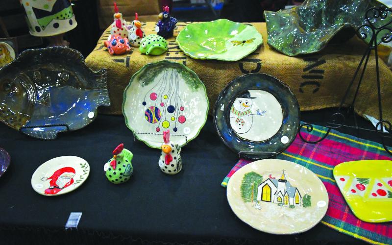Luke Morey/The Clayton Tribune. Marcia Scroggs of L.A. Arts displayed her hand-crafted pottery. All the plates were made without a wheel and painted.