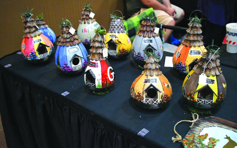 Luke Morey/The Clayton Tribune. Sue Aaron of Sue’s Arts and Crafts offered birdhouses as well as paintings at the two-day Festival of Trees event at the county civic center. Aaron also offers art classes on top of her paintings.