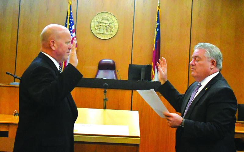 Megan Broome/The Clayton Tribune. James V. Blalock takes the oath of office as Rabun County magistrate judge as he is sworn-in by Judge Russell W. Smith.