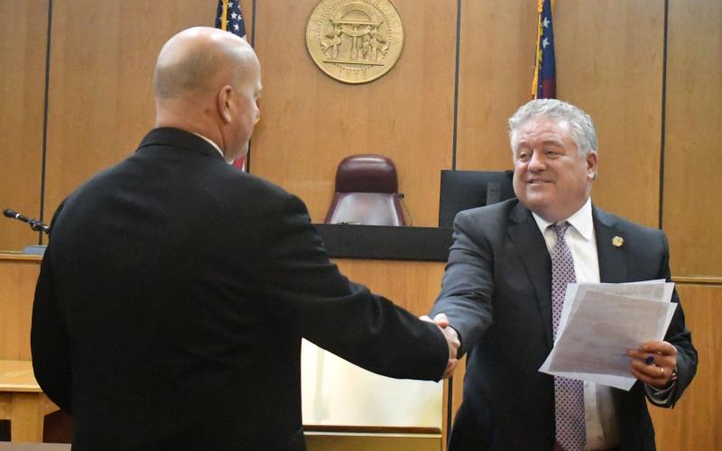 Megan Broome/The Clayton Tribune. Magistrate Judge James V. Blalock shakes hands with Judge Russell W. Smith after taking the oath of office on Dec. 29, 2022, at the Rabun County Courthouse. 