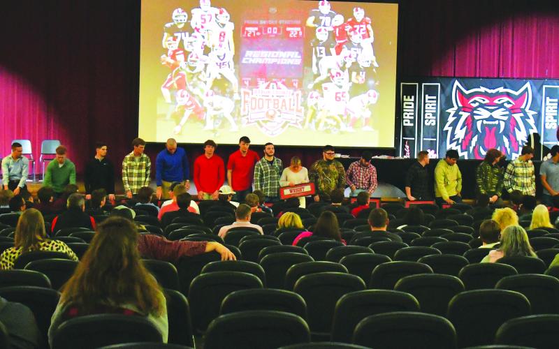 Luke Morey/The Clayton Tribune. On Sunday, Feb. 5, Rabun County High School honored the 2022 football team after their 12-1 season. RCHS head coach Michael Davis (pictured speaking) addressed the 19 seniors after their final season as  Wildcats. The seniors went 47-6 overall with a 16-0 region record. Pictured with the 19 seniors is senior student manager Molly Jo Wright (center).