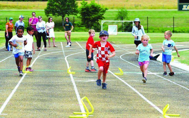 Luke Morey/The Clayton Tribune. Six Rabun Gap campers compete in a relay during  the Olympics event.