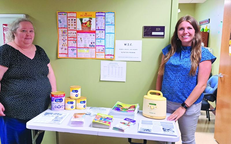 Megan Broome/The Clayton Tribune. Alyssa Hurt, CPA/Nutritionist and Dawnia Sanborn, WIC clerk, provide educational resources and information about Georgia Women, Infants, and Children (WIC), the nation’s fifth largest Special Supplemental Nutrition Program for Women, Infants and Children, at the Rabun County Health Department meet and greet event June 6. 