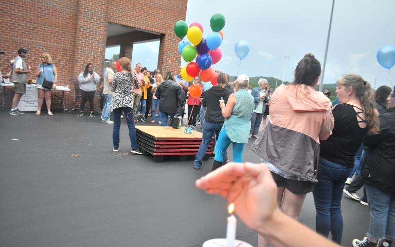 Megan Broome/The Clayton Tribune. Rabun County community members lit candles and released 23 balloons for Frank Hanrahan to honor his life and represent his years of service to Ingles. 