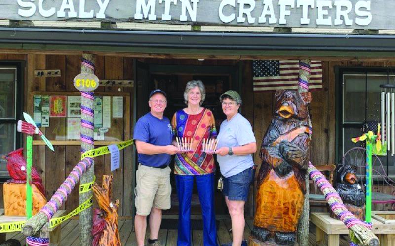 Submitted photo. Michelle and Darren Gillett of Scaly Mountain Crafters (Pens with a Purpose), present a donation to Dee Vollmer with the Scaly Mountain Women’s Club. Below:  A group of the donated pens.