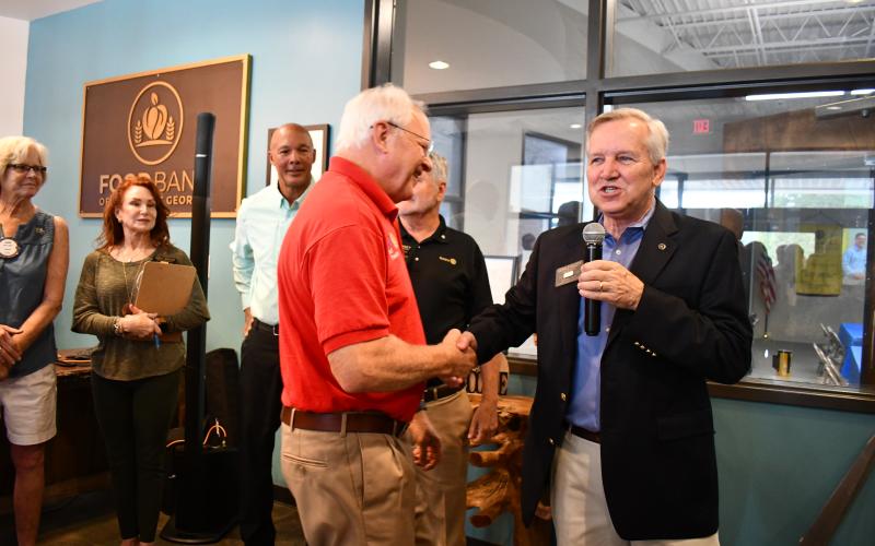 Megan Horn/The Clayton Tribune. Rotarian Jef Fincher is thanked by Rotary Club of Clayton President Gerald Hulett during the grand opening and dedication event Sept. 14. Fincher was a rotary project manager for A/V design and installation. 