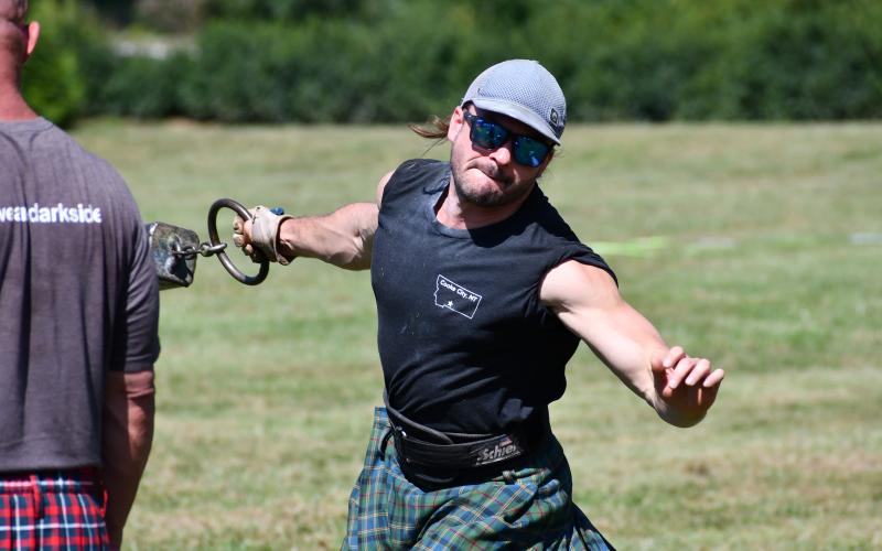 Wade Cheek/The Clayton Tribune. In the weight for distance throw, the weight is thrown with one hand from a rectangular area behind a toe board or trig. The younger male division competed in this event first during the Sept. 30 North Georgia Highland Games.