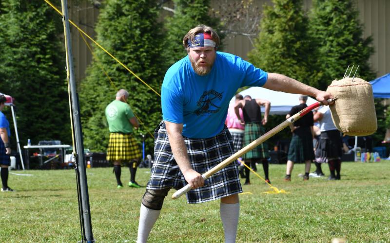 Wade Cheek/The Clayton Tribune.  Tossing the Sheaf is one of the traditional events in the Highland Games where a 20-pound burlap bag stuffed with straw is thrown over a set bar.