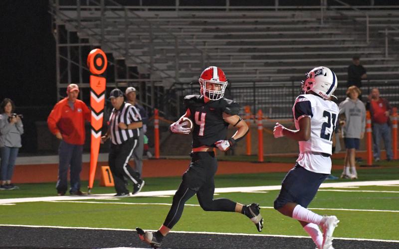 Wade Cheek/The Clayton Tribune. RCHS running back Noah English scores his first of two touchdowns, a 17-yard run, in last Friday’s route of the Knights. 