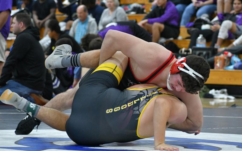 Wade Cheek/The Clayton Tribune. RCHS senior wrestler Justin Cody twists and pins a Murphy High School opponent during this year's King of the Mountain Invitational.
