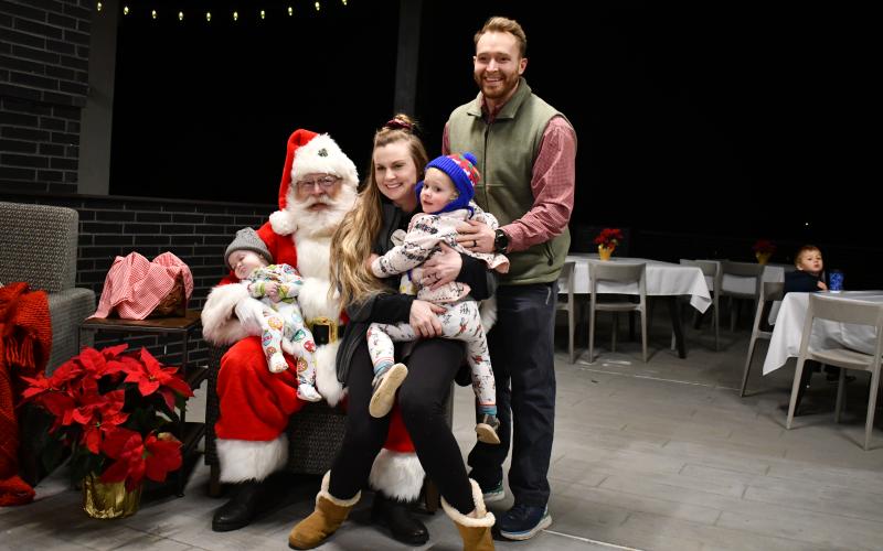 Megan Horn/The Clayton Tribune, The Stroud family of Victoria, Josh, 5-month-old Shepherd and 2-and-a-half-year-old Eden pose with Santa at Mountain Lakes Medical Center during the Dec. 14 event. 