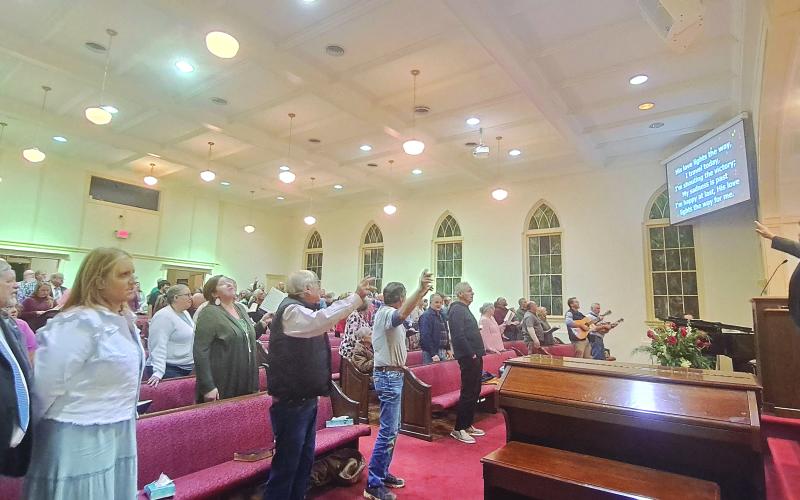 Megan Horn/The Clayton Tribune. Those in the congregation at the Head of Tennessee Baptist Church in Dillard sing during a night of the revival. Since its beginning on Oct. 29, as many as 133 individuals have been saved as that total rises.