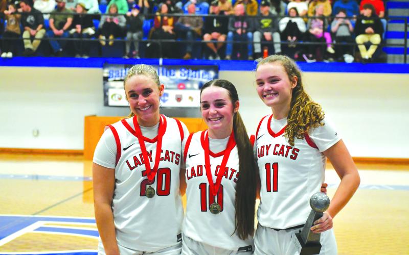 Wade Cheek/The Clayton Tribune. Senior guards (from left) Ellie Southards, Mili Watts and Lucy Hood pose with their well-deserved hardware after winning the 29th-annual Battle of the States tournament in Towns County on Dec. 30.