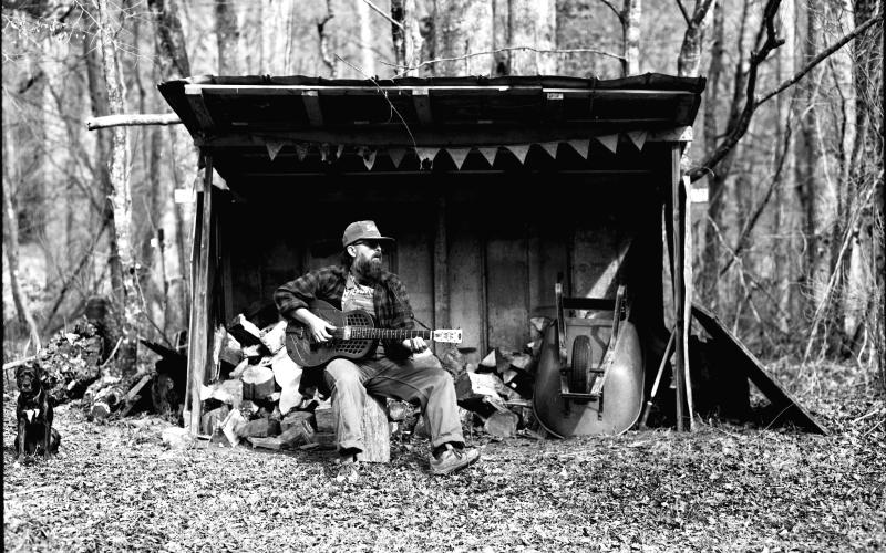 Photo courtesy Ronnie Pettit. This black-and-white photograph by Ronnie Pettit shows Rabun County resident Scott Low as he promotes his new album “Appalachian Blues.” Low has release parties scheduled in three states.