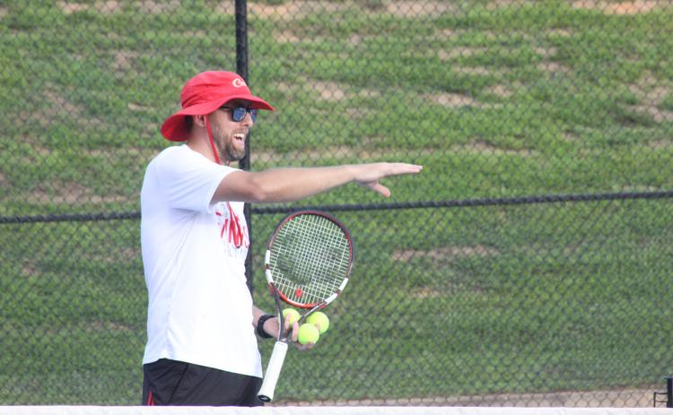 Rabun County tennis coach Bryan Getty instructs players during the Wildcat Tennis Academy at Rabun County High School’s tennis courts Monday night. (Glendon Poe/The Clayton Tribune)