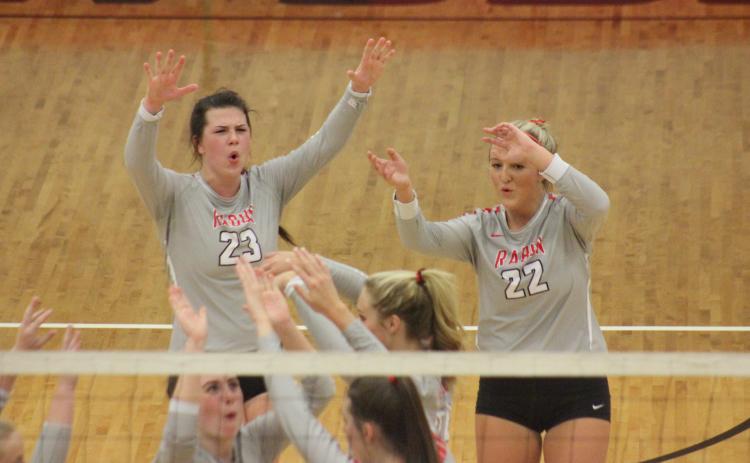 Rabun County’s Destiny Deetz (23), Lexi Crump (22) and teammates celebrate a point against Armuchee during the first round of the GHSA Class A/AA-Public state playoffs in Tiger last Saturday. (Glendon Poe/The Clayton Tribune)