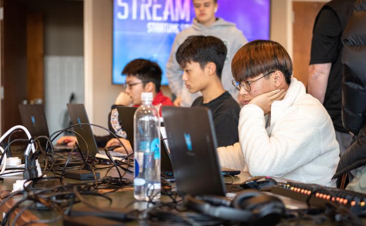 E. Lane Gresham/Tallulah Falls School. Shown in the foreground is Tallulah Falls School junior Justin Yu of South Korea during the Jan. 21 Esports Elite Eight match versus Lambert High School. Also shown, front to back, are team members Daniel Shin of South Korea and Janson Zhou of the People's Republic of China, both freshman.