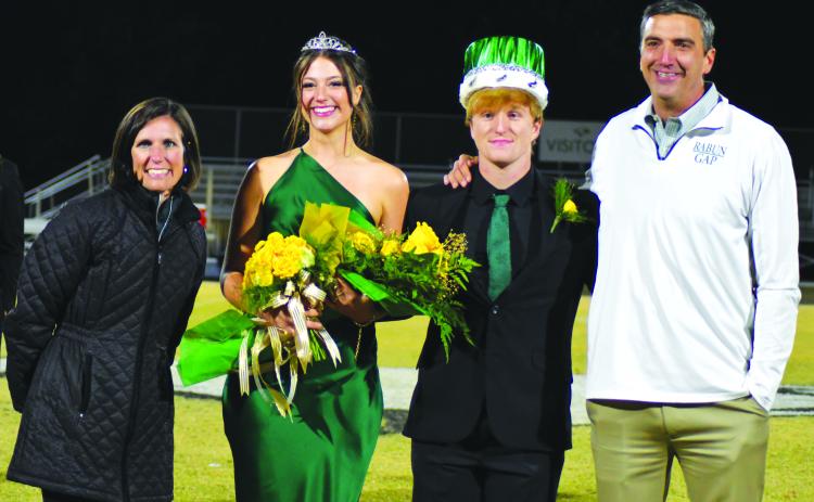 Enoch Autry/The Clayton Tribune. Homecoming Queen Cheney Moriarty and King Zeke Coghill pose with Head of School Jeff Miles and wife Kiana Miles.