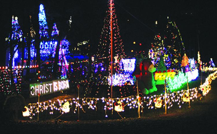File photo. Visitors to the Christmas Village of Lights travel a path outlined in candy canes to visit Santa and the miniature indoor village display. Also, visitors can take part in a scavenger hunt through the village sets. 