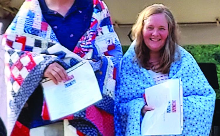 Eric Miller, MSgt., U.S. Army and the U.S. Air Force, from 1982-2010, and Aurore Miller, Sgt., U.S. Air Force, Jan 86-88, Cold War are awarded Quilts of Valor by the Misty Mountain Quilters Guild at a July 4 ceremony. 