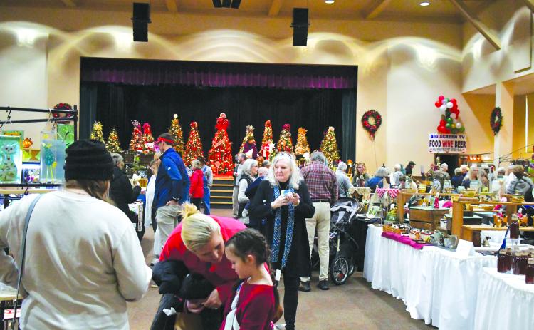 Luke Morey/The Clayton Tribune. Hundreds of visitors showed up to the Festival of Trees on Nov. 25 and 26 to see the 39 vendors who offered an array of items including mugs, wreaths, candles, award-winning BBQ sauce and paintings.