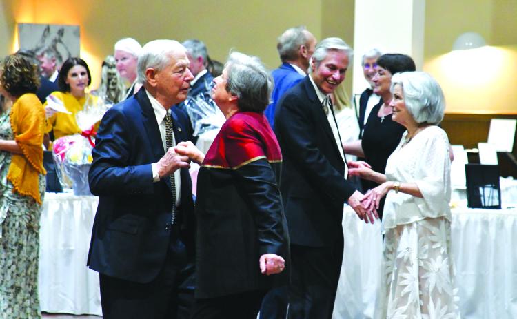 Enoch Autry/The Clayton Tribune. Couples Tom and Becky Callahan (foreground) and Greg and Willa Presmanes, all of Tiger, dance at the F.A.I.T.H. benefit Sweetheart Ball on Feb. 11 in the Rabun County Civic Center as the band “Party at the Limit” from Atlanta plays music.  The event that was catered by The Shed raises funds for F.A.I.T.H. programs that “fight abuse in the home.”
