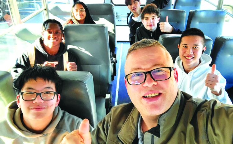 Submitted photo. Scott Davis, coach of the Tallulah Falls Robotics Club, rides in the bus to the competition. On the bus with Davis are Seungwook Shin, Nana Amankwah, Lily Desta, Yen Chou, Luka Kutateladze, and William Xu.