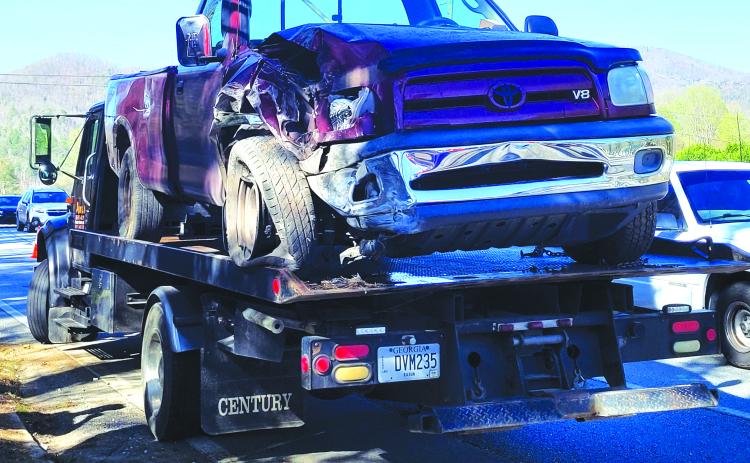 Megan Broome/The Clayton Tribune. This red 2006 Toyota Tundra, driven by a Mountain City man, went off the roadway in Mountain City, striking a power pole and concrete barrier. 