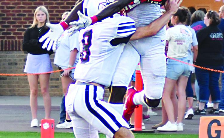 Enoch Autry/The Clayton Tribune. The No. 3-ranked Rabun County Wildcats got the 2023 football season started in good fashion on Aug. 18 thanks to a lot points in the first two quarters as the Wildcats went into the locker room up 38-0. ABOVE: RCHS senior receiver Willie Goodwyn corrals a touchdown pass off the back of Haralson County defender Kaegen Williams to increase the Wildcats advantage. BELOW: RCHS sophomore quarterback Ty Truelove in his first career start goes in for six. He also threw for four tou