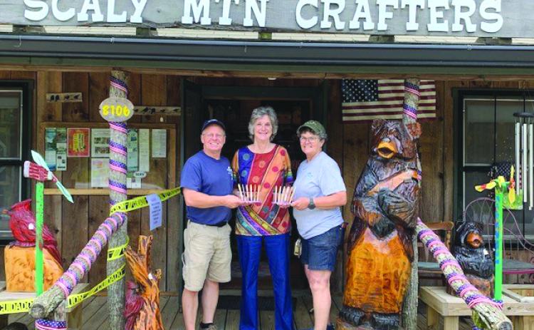Submitted photo. Michelle and Darren Gillett of Scaly Mountain Crafters (Pens with a Purpose), present a donation to Dee Vollmer with the Scaly Mountain Women’s Club. Below:  A group of the donated pens.