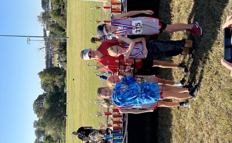 Head rec cross country coach Ed Edison celebrates with his 10-and-under boys team after they won first place in the GRPA state championship in Jefferson last Saturday. Kai Hannifan-Wagner placed first in that race and finished 36 seconds before any other runner. 