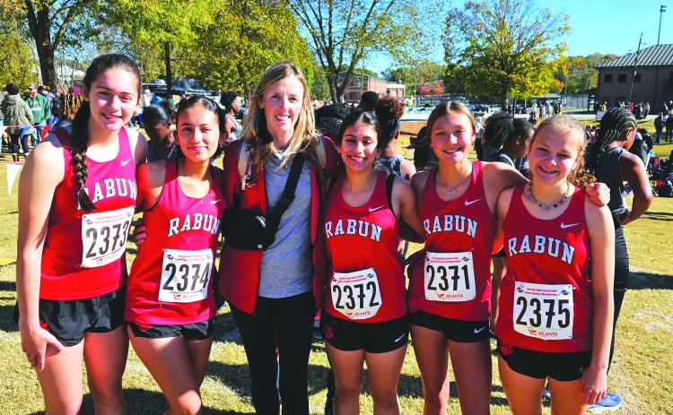 Submitted. The Lady Cat cross country team poses for a photo with their head coach April Adcock at last Friday’s state meet in Carrollton. The Lady Cats finished 14th in state despite many injuries and illnesses during the season.