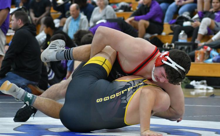 Wade Cheek/The Clayton Tribune. RCHS senior wrestler Justin Cody twists and pins a Murphy High School opponent during this year's King of the Mountain Invitational.