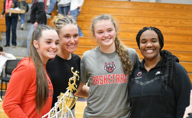 Wade Cheek/The Clayton Tribune. Lady Cat basketball seniors from left Mili Watts, Ellie Southards, Lucy Hood and Isia Wilmont stand together after defeating Athens Christian in the region title game earlier this year. 