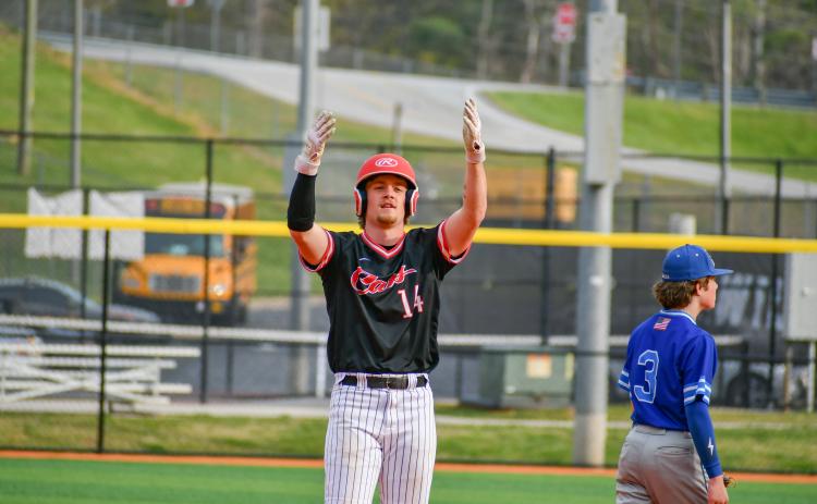 Wade Cheek/The Clayton Tribune. Cooper Welch celebrates in the direction of his Wildcat teammates in Rabun County’s 8-1 win over Barrow Arts and Sciences at home on April 8.