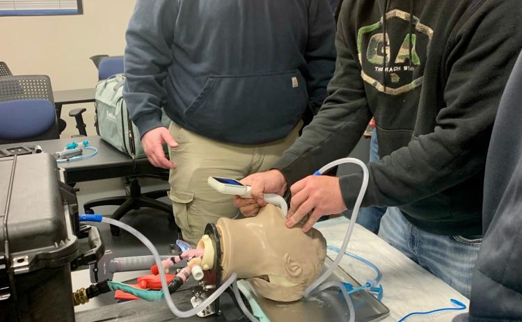 Photos courtesy Rabun County EMS. Lt. Jared Coleman and Firefighter/AEMT Dalton Freeman participate in Rabun County EMS hands-on instruction on new lifesaving skills and procedures during an Advanced Airway Training course obstructed by Jennifer Davis of AirLife Georgia on March 19.