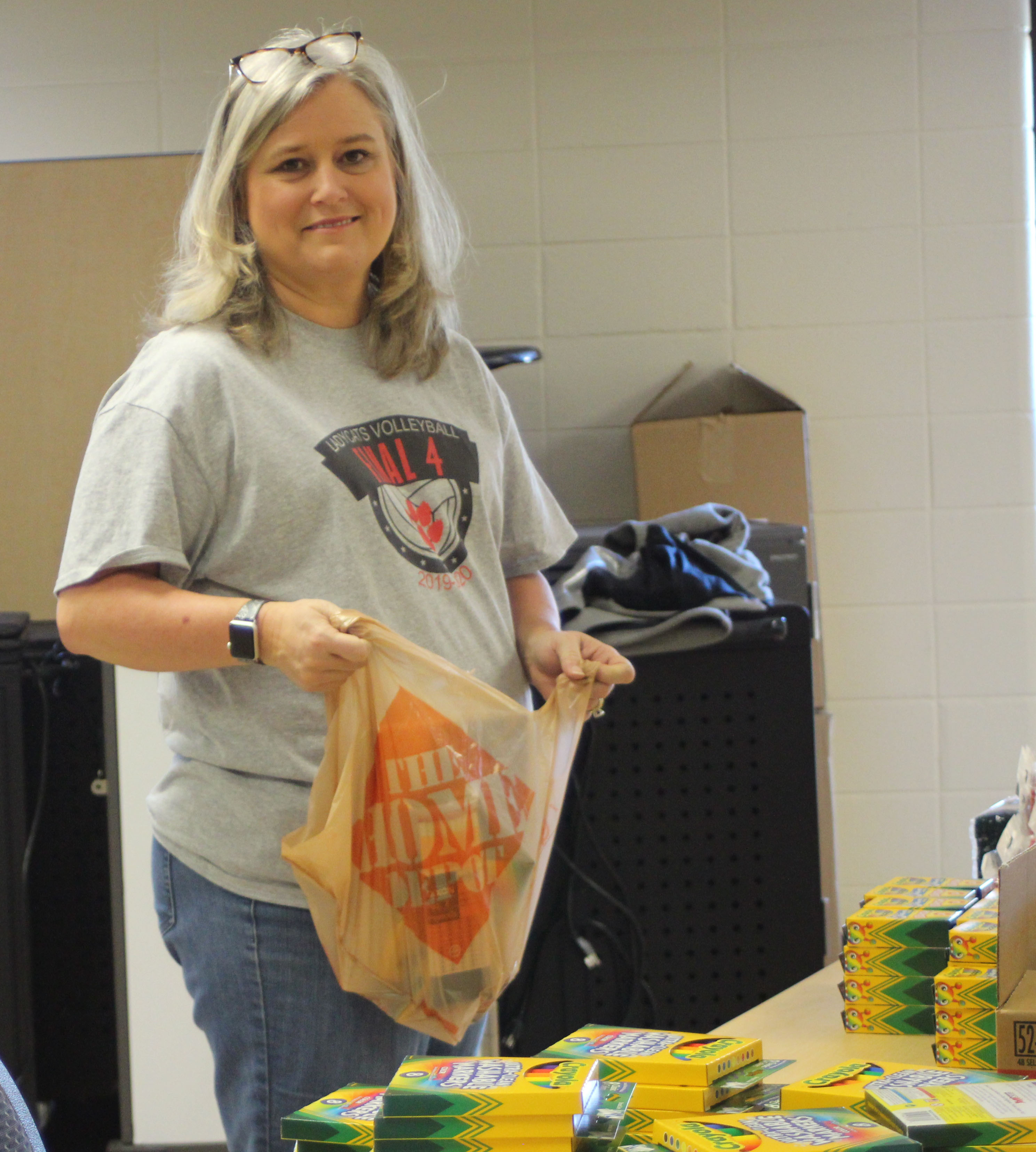 Megan Broome/The Clayton Tribune. Dr. April Childers, superintendent of Rabun County Schools, helps pack bags of art supplies at the Board of Education Friday, to hand out during meal distribution on Monday, April 6. 