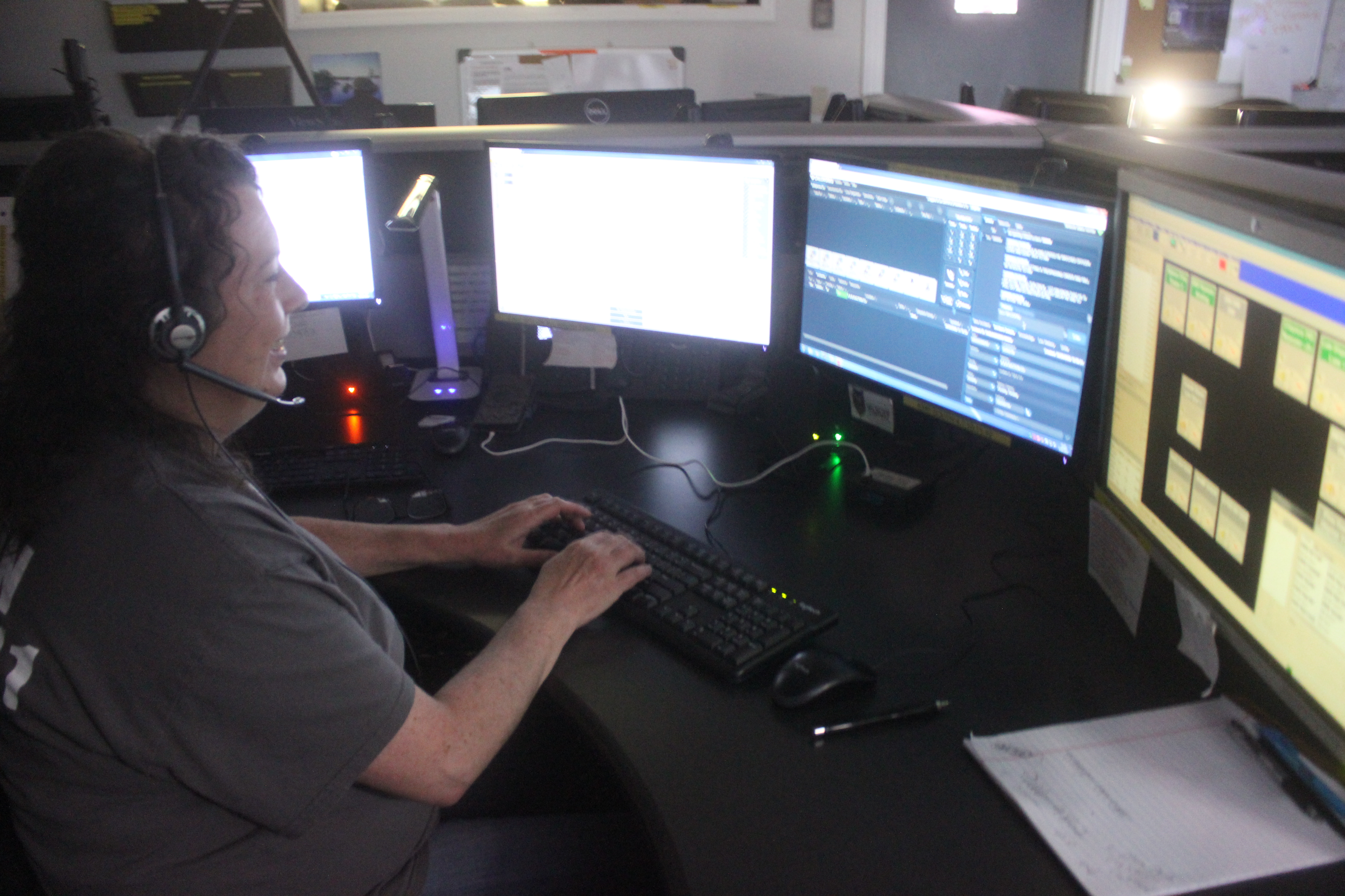 Megan Broome/The Clayton Tribune. Becky Dryman answers calls and multitasks at the Rabun County 911 Dispatch Center. 