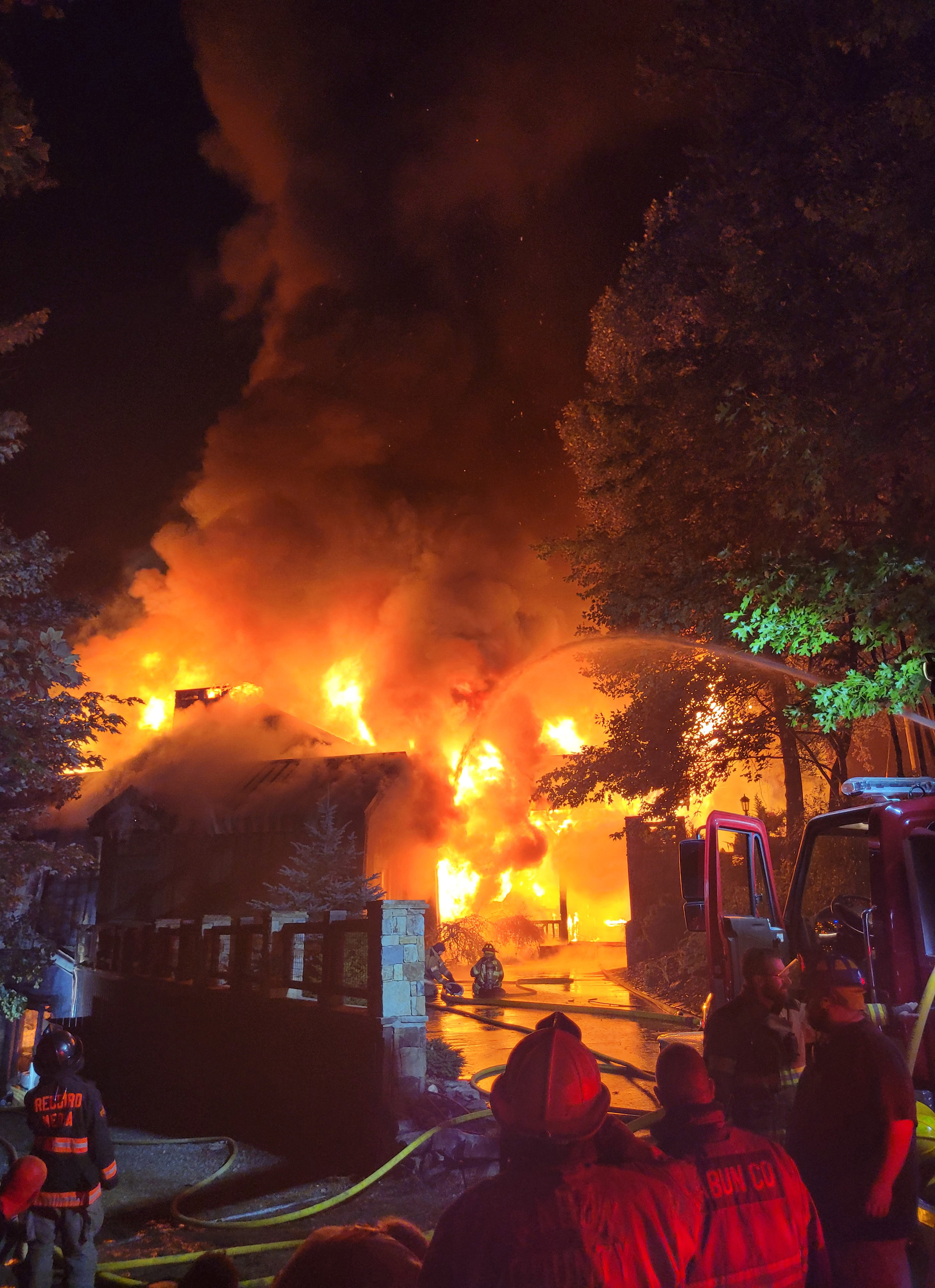 Megan Broome/The Clayton Tribune. Rabun County Fire Services requested mutual aid to fight a three-story structure fire on Lake Rabun Monday evening. The home was a complete loss. 