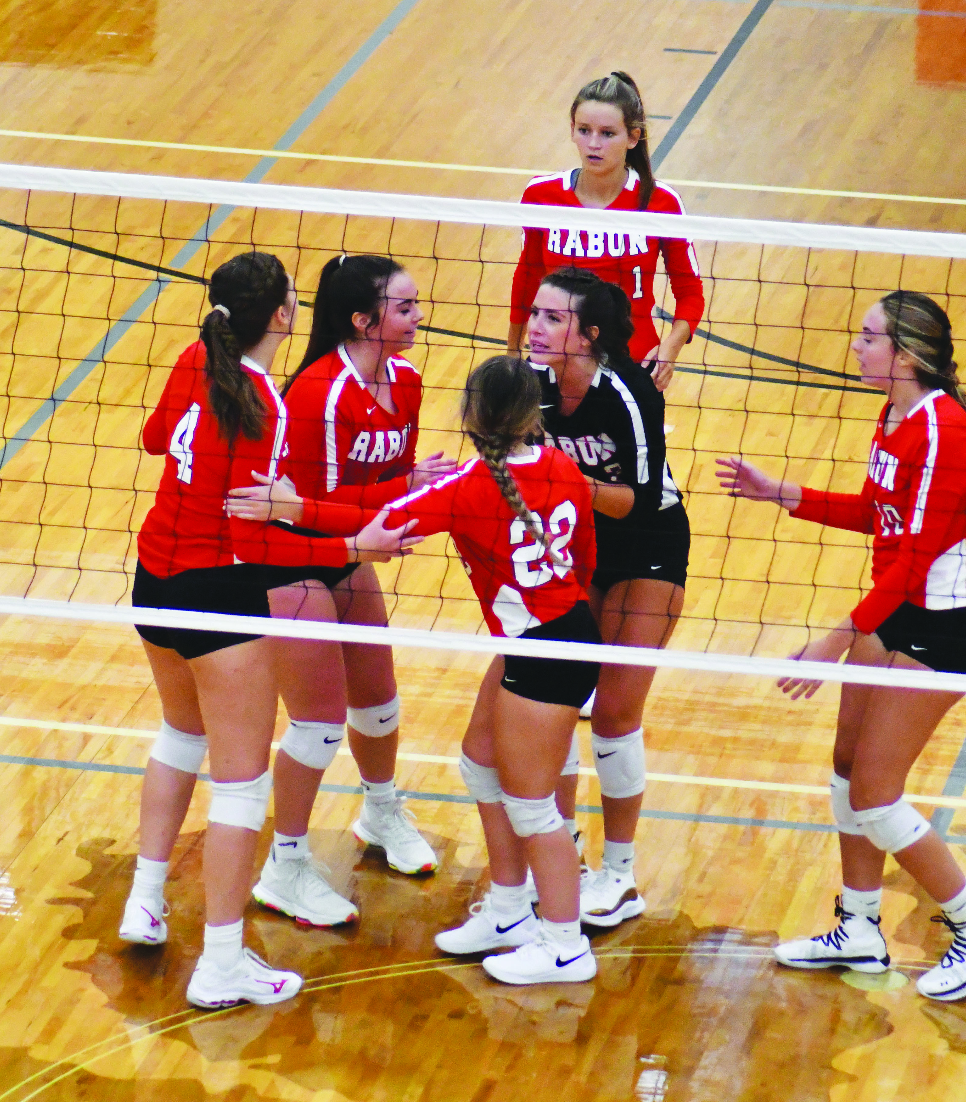 Enoch Autry/The Clayton Tribune.  Lady Cat players congratulate each other after RCHS scored a point against Seckinger.